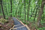 Custom hiking trail to creek and fire pit.